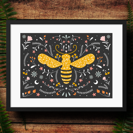 Framed artwork of a yellow bee with floral patterns on a dark background