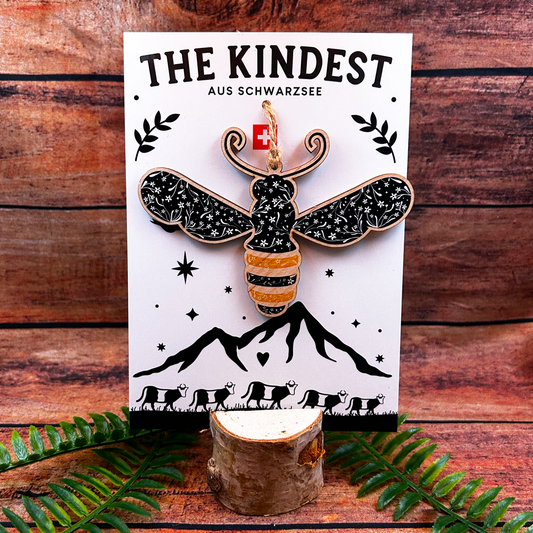 Folk art modern floral illustration of a bee on a wooden decoration backing card