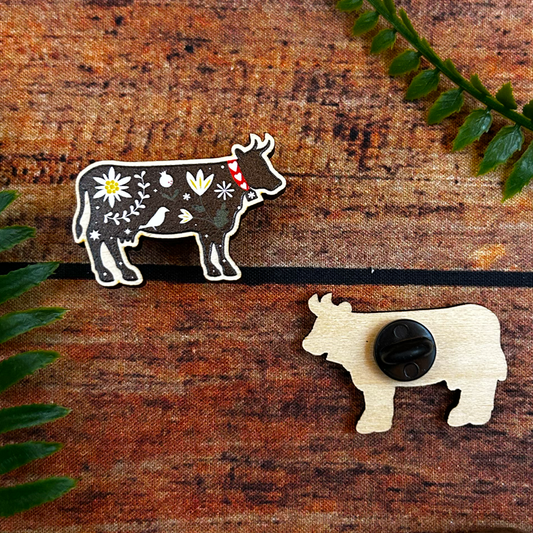 swiss cow illustration on wooden pin badge souvenir of switzerland