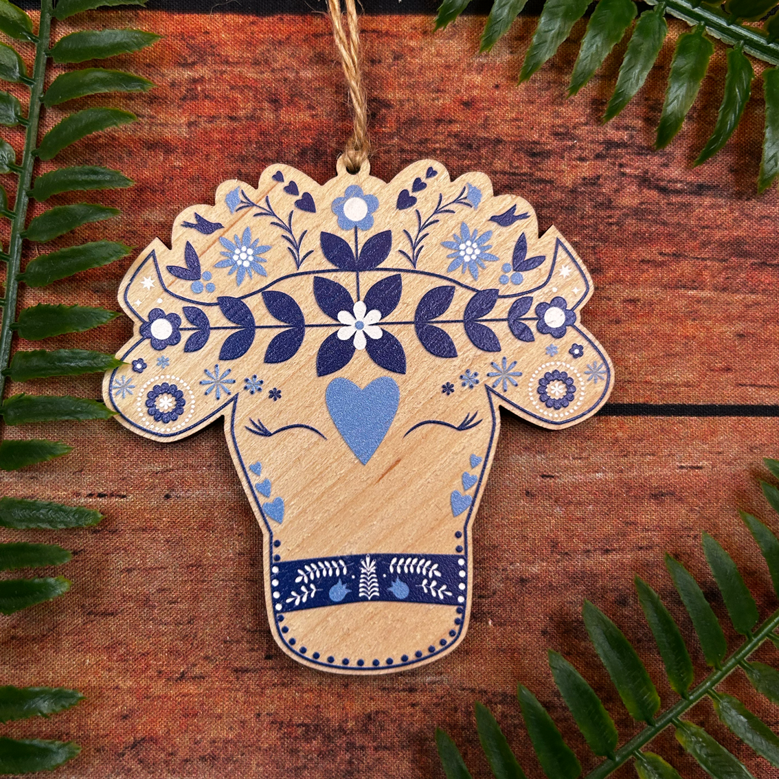 Modern Swiss alpine cow illustration on wooden decoration