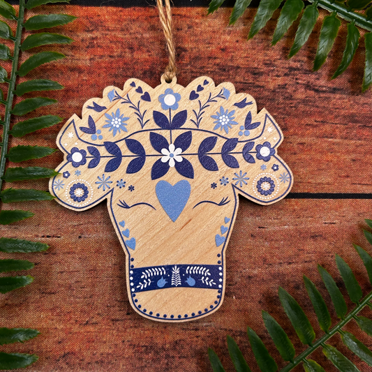 Modern Swiss alpine cow illustration on wooden decoration