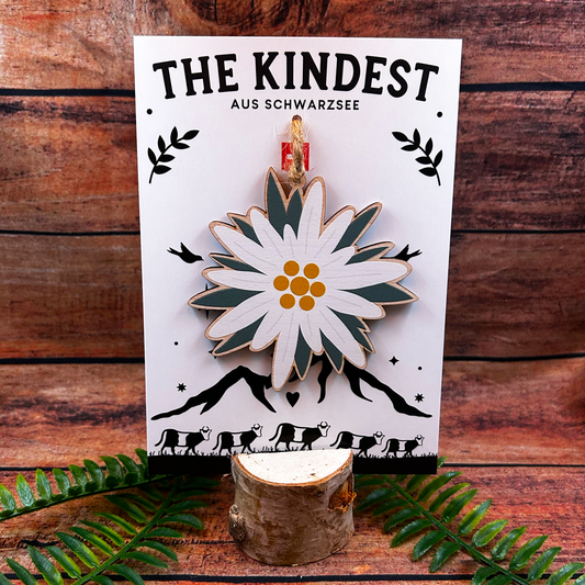 swiss edelweiss illustration on wooden decoration presented on backing card as a switzerland souvenir