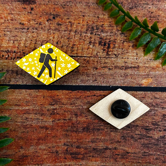 traditional swiss hiking trail wanderweg sign on wooden pin badge with illustrated flowers