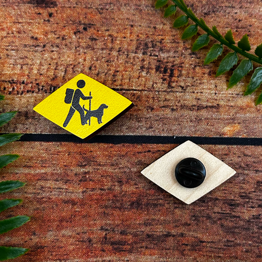 traditional swiss hiking trail or wanderweg signage with dog on wooden pin badge switzerand souvenir