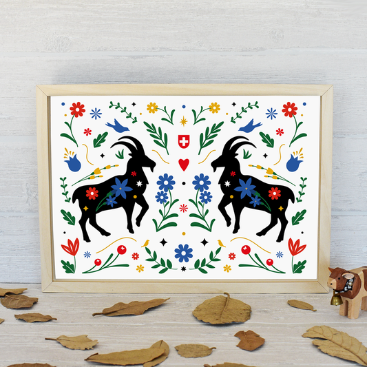 Framed artwork with black ibex and colorful flowers on a white background, placed on a wooden surface.