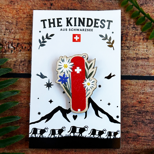 Illustrated Switzerland pocketknife design on wooden pin badge presented on a backing card, Swiss souvenir and gift.