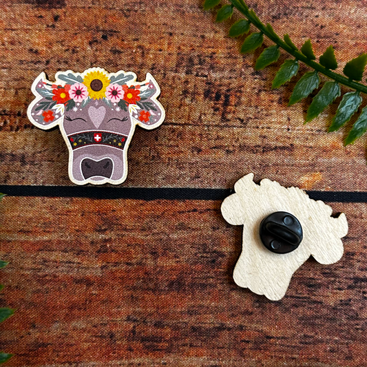 illustration of swiss cow with flowers on wooden pin badge switzerland souvenir