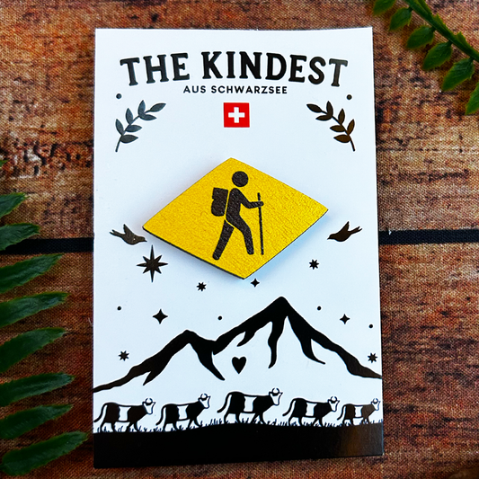 wooden pin badge with swiss hiking trail wanderweg symbol on backing card, souvenir of switzerland