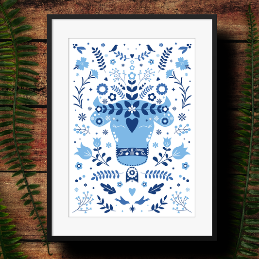 Framed artwork of a modern, abstract cow illustration with lots of flowers in various blue tones. 