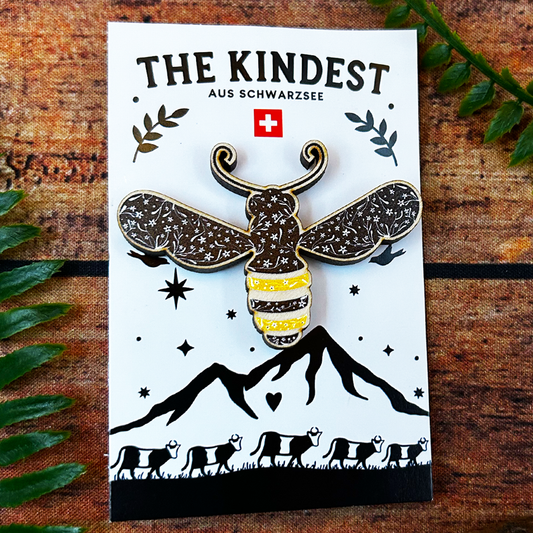 floral illustration of a bee on a wooden pin badge and presented on a backing card