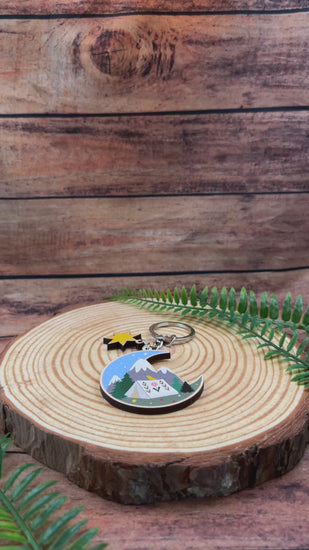 video of a camping keyring with swiss mountains and stars