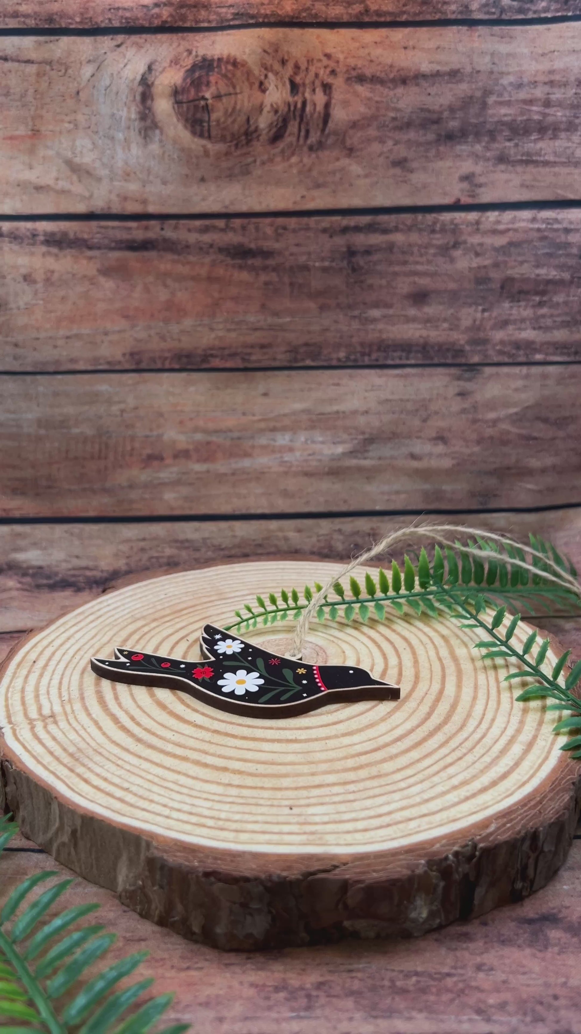 video showing Decorative folk art  bird illustration on wooden decoration