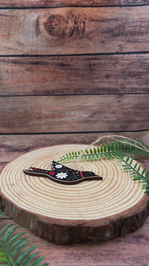 video showing Decorative folk art  bird illustration on wooden decoration