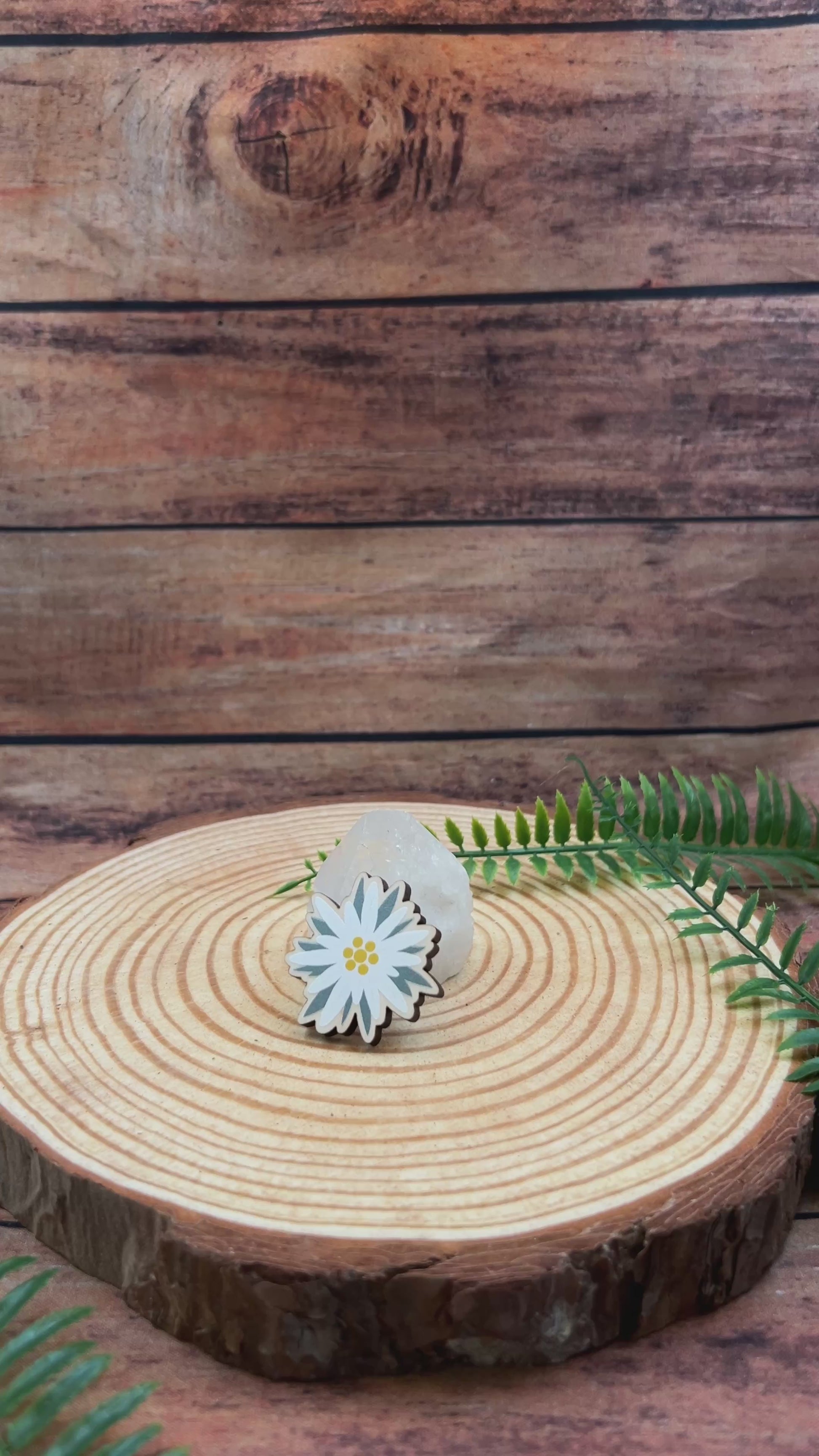 video showing modern edelweiss illustration on a wooden pin badge souvenir of switzerland
