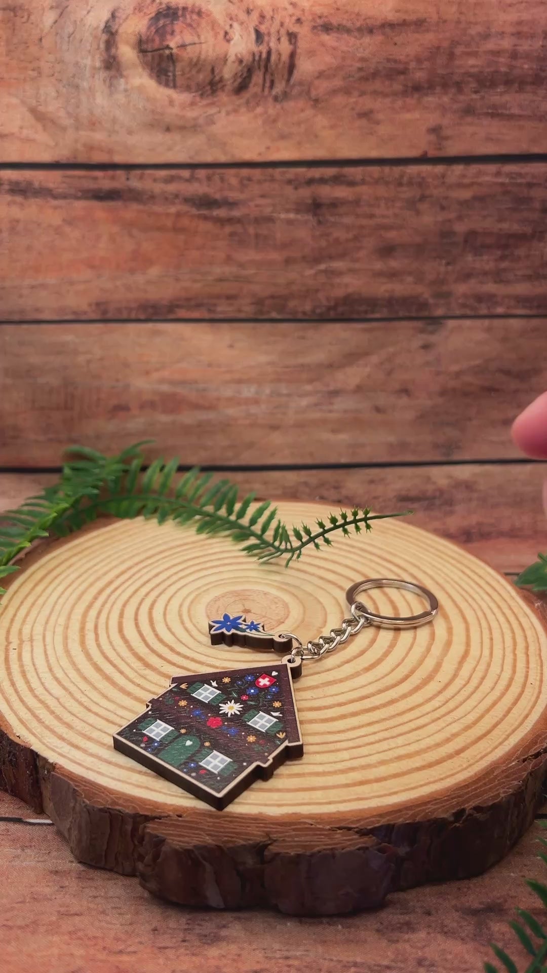 video of swiss chalet keyring with floral design